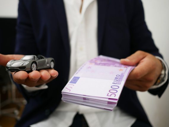 Rent luxury car - person holding money